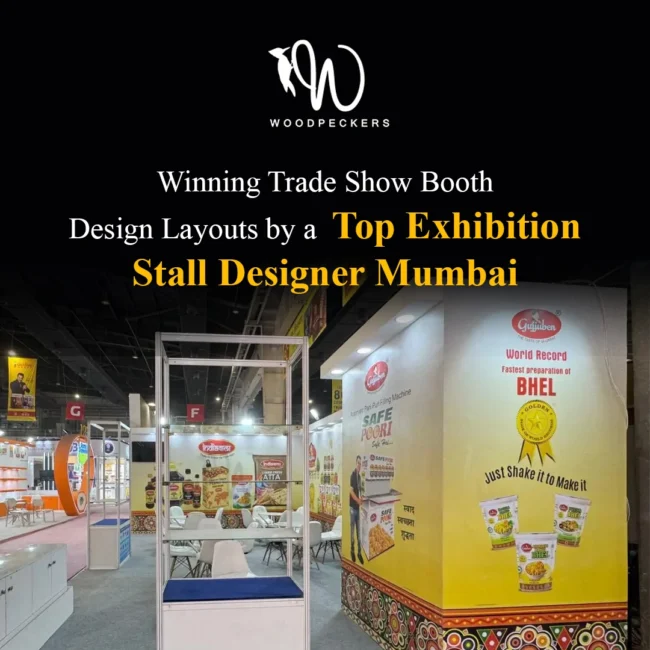 Trade Show Booth Design Layouts by Exhibition Stall Designer Mumbai – Gujjuben Stall Trade show booth layout designed by Woodpeckers for Gujjuben and Indiawala at a food expo in Mumbai, featuring glass product display towers, vibrant branded pillars, and visitor seating.