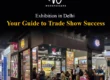 Exhibition booth fabricated by Woodpeckers for Anil & Company at a trade show in Delhi, featuring overhead spotlights, product display racks, and B2B discussion tables.