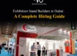 Custom trade show booth fabricated by Woodpeckers for Glatt, featuring modern curved overhead fascias, red and white corporate branding, backlit poster panels, and client meeting counters.