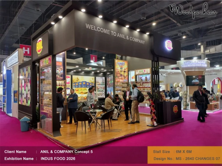 Modern 6x6 meter trade show booth designed by Woodpeckers for Anil & Company at Indus Food exhibition in Delhi featuring product displays and meeting areas.